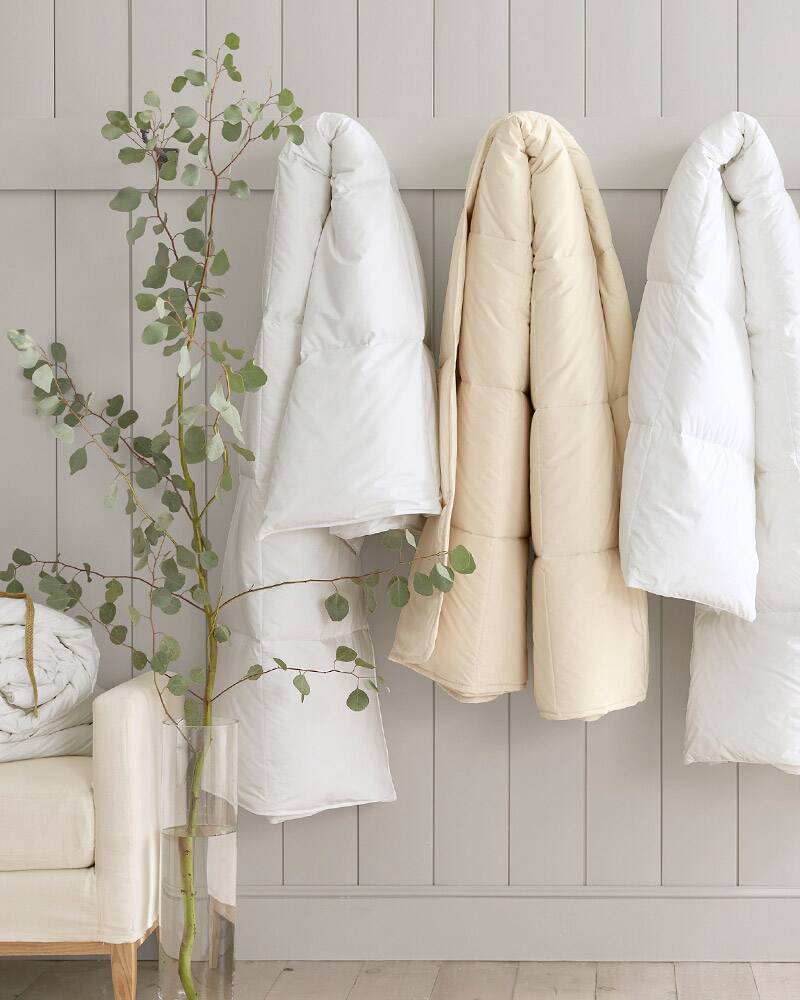 image of woman putting on a duvet cover